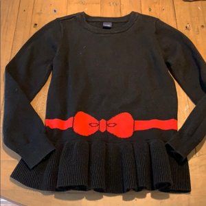 black sweater with red bow